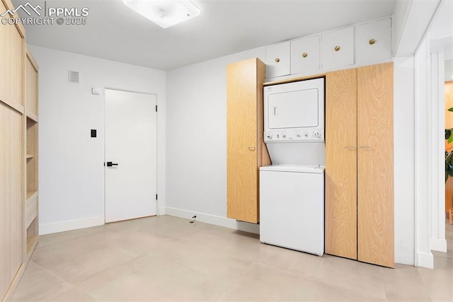 312 Lake Ave, Colorado Springs, CO 80906 - washroom with stacked washing machine and dryer and baseboards