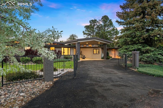 312 Lake Ave, Colorado Springs, CO 80906 - view of front of house featuring asphalt driveway, a fenced front yard, a gate, a carport, and stucco siding