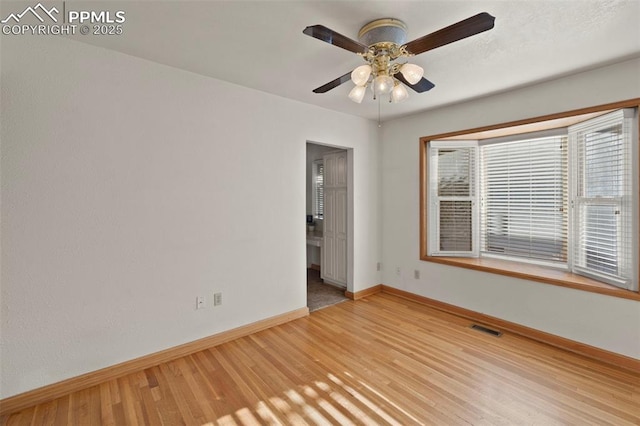 229 E Washington St, Colorado Springs, CO 80907 - spare room featuring baseboards, light wood-style floors, and a ceiling fan
