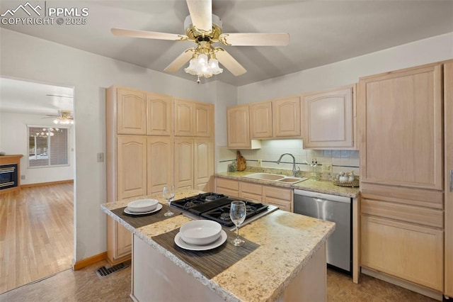 229 E Washington St, Colorado Springs, CO 80907 - kitchen with light brown cabinets, a sink, stainless steel appliances, and a kitchen island
