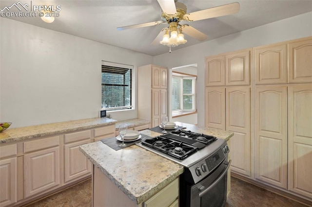 229 E Washington St, Colorado Springs, CO 80907 - kitchen with gas range, ceiling fan, light brown cabinets, a kitchen island, and light stone countertops