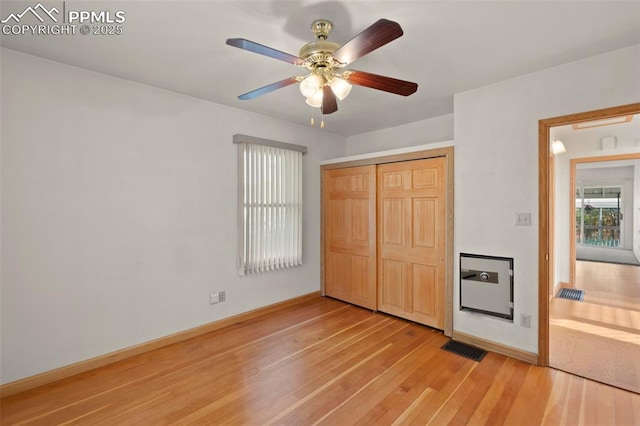 229 E Washington St, Colorado Springs, CO 80907 - unfurnished bedroom featuring light wood-type flooring, a closet, baseboards, and a ceiling fan
