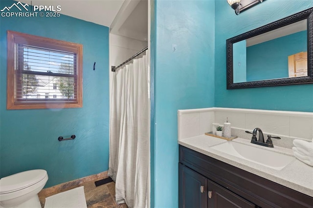 229 E Washington St, Colorado Springs, CO 80907 - bathroom featuring toilet, vanity, baseboards, and a shower with curtain