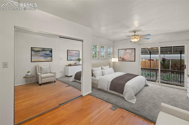 229 E Washington St, Colorado Springs, CO 80907 - bedroom featuring access to exterior, hardwood / wood-style floors, a closet, a textured ceiling, and ceiling fan