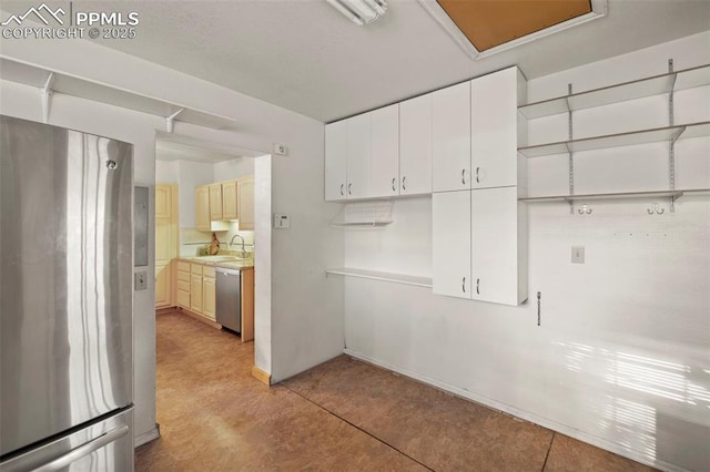 229 E Washington St, Colorado Springs, CO 80907 - kitchen with appliances with stainless steel finishes, baseboards, light countertops, and a sink
