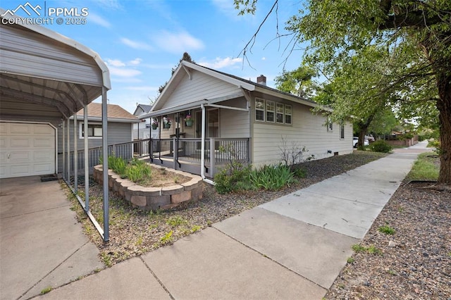 229 E Washington St, Colorado Springs, CO 80907 - view of home's exterior featuring a porch, a garage, and a chimney