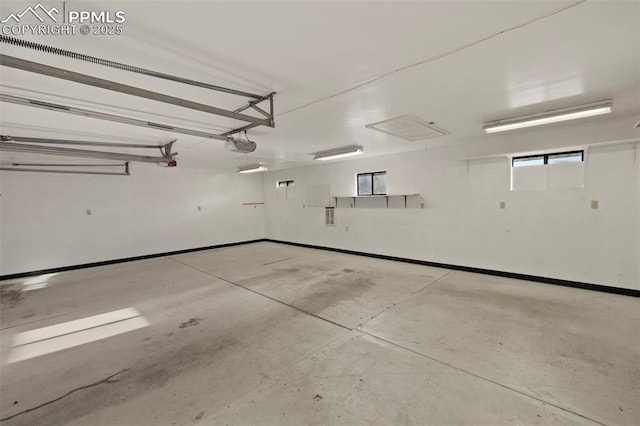 229 E Washington St, Colorado Springs, CO 80907 - garage with baseboards and a garage door opener