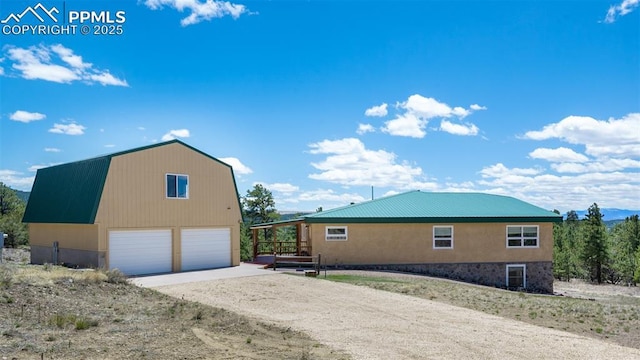 610 Matterhorn Cir, Westcliffe, CO 81252 - view of property exterior featuring a garage, an outbuilding, a gambrel roof, and metal roof