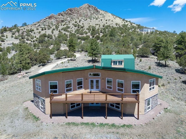 610 Matterhorn Cir, Westcliffe, CO 81252 - rear view of house with french doors, stucco siding, and a deck with mountain view
