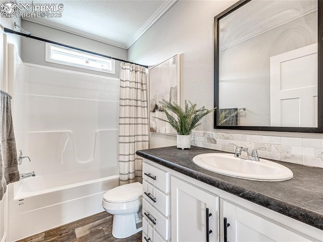 772 7th St, Penrose, CO 81240 - bathroom with crown molding, toilet, vanity, shower / bath combo, and decorative backsplash