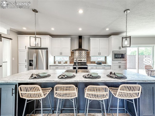 772 7th St, Penrose, CO 81240 - kitchen with wall chimney exhaust hood, appliances with stainless steel finishes, a sink, white cabinetry, and crown molding