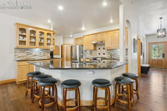 20190 Deer Shadow Way, Monument, CO 80132 - kitchen featuring under cabinet range hood, a sink, light brown cabinets, glass insert cabinets, and recessed lighting