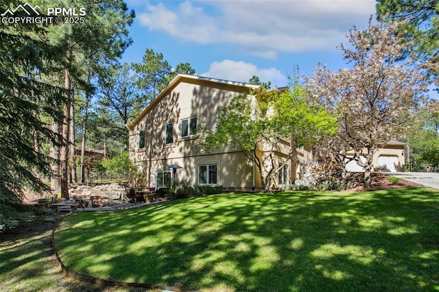 20190 Deer Shadow Way, Monument, CO 80132 - view of front facade featuring a front yard, concrete driveway, stucco siding, and an attached garage