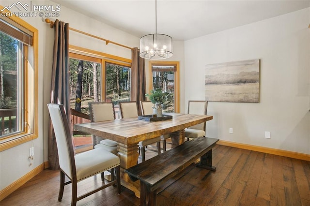 20190 Deer Shadow Way, Monument, CO 80132 - dining space featuring a chandelier, baseboards, and wood-type flooring