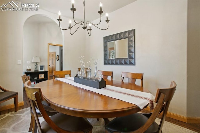 20190 Deer Shadow Way, Monument, CO 80132 - dining area with arched walkways, baseboards, a chandelier, and wood finished floors