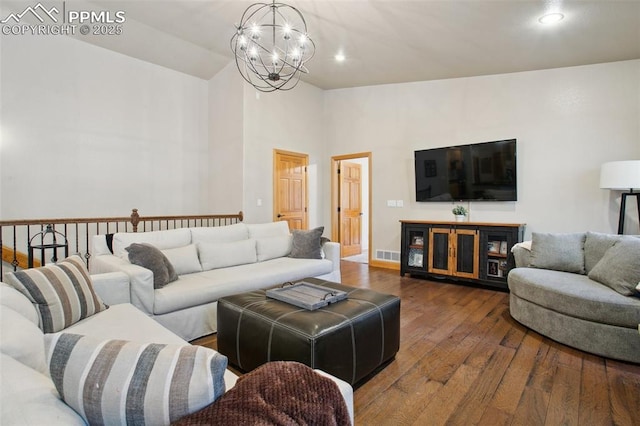 20190 Deer Shadow Way, Monument, CO 80132 - living room with hardwood / wood-style flooring, a chandelier, high vaulted ceiling, recessed lighting, and baseboards