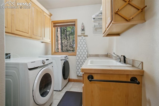 20190 Deer Shadow Way, Monument, CO 80132 - laundry area with cabinet space, washing machine and dryer, and light tile patterned floors