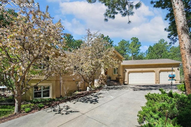 20190 Deer Shadow Way, Monument, CO 80132 - view of front of home featuring stucco siding, a garage, and driveway