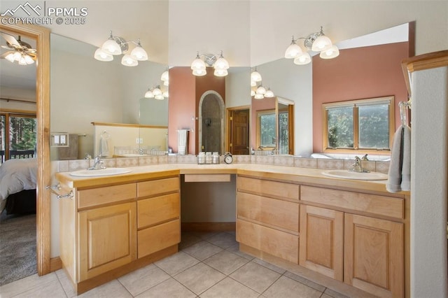 20190 Deer Shadow Way, Monument, CO 80132 - full bath with tile patterned floors, ensuite bath, double vanity, ceiling fan, and high vaulted ceiling
