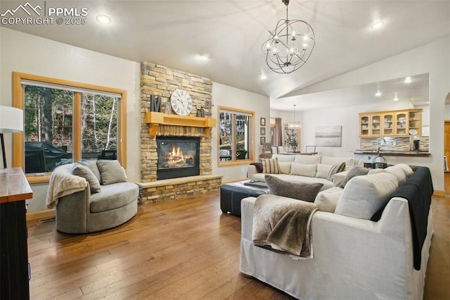 20190 Deer Shadow Way, Monument, CO 80132 - living room with a chandelier, hardwood / wood-style flooring, lofted ceiling, a fireplace, and recessed lighting