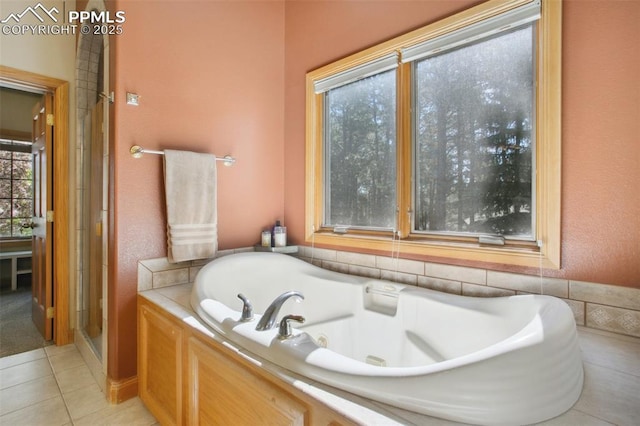 20190 Deer Shadow Way, Monument, CO 80132 - full bathroom with tile patterned flooring, a garden tub, and a shower stall