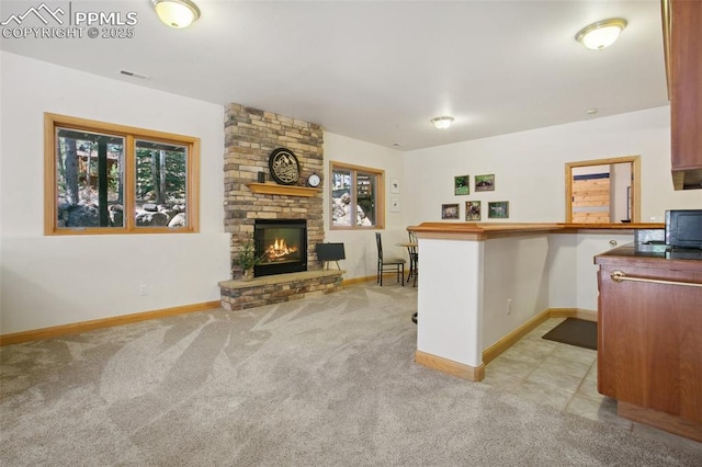 20190 Deer Shadow Way, Monument, CO 80132 - living room featuring light carpet, baseboards, and a fireplace