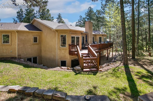 20190 Deer Shadow Way, Monument, CO 80132 - back of property with a wooden deck, a lawn, stucco siding, and a chimney