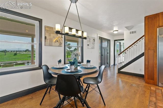 16030 Alta Plaza Cir, Peyton, CO 80831 - dining room with plenty of natural light, stairs, and wood finished floors