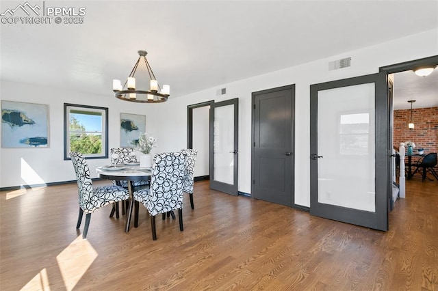 16030 Alta Plaza Cir, Peyton, CO 80831 - dining space featuring a chandelier, wood finished floors, and french doors