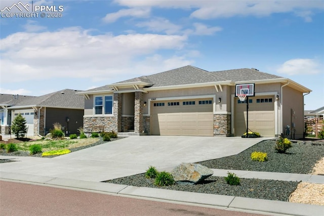 6562 Mancala Way, Colorado Springs, CO 80924 - prairie-style home with a garage, driveway, stone siding, and stucco siding