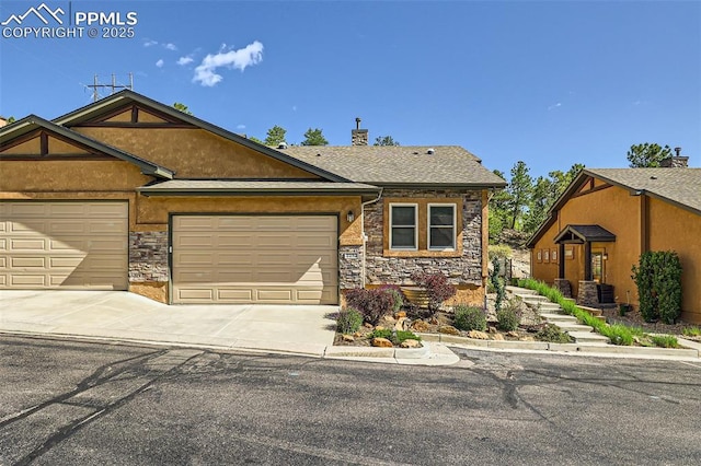 2252 Conservatory Pt, Colorado Springs, CO 80918 - view of front of property with stone siding, concrete driveway, a garage, and stucco siding