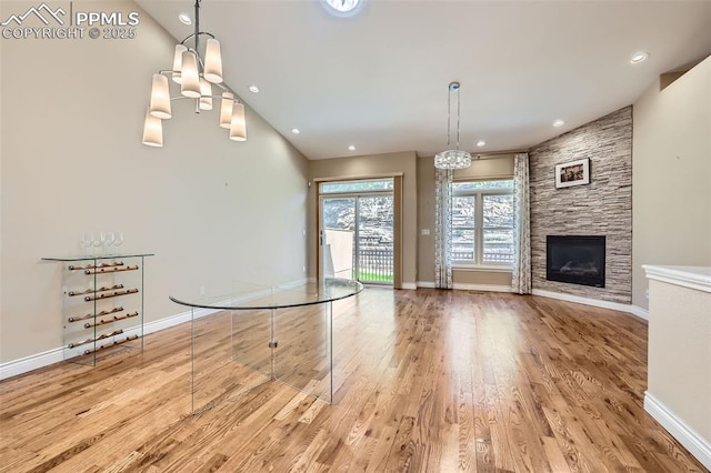 2252 Conservatory Pt, Colorado Springs, CO 80918 - unfurnished living room with wood finished floors, baseboards, a chandelier, and recessed lighting