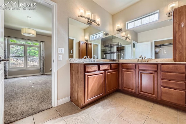 2252 Conservatory Pt, Colorado Springs, CO 80918 - bathroom with plenty of natural light, double vanity, tile patterned floors, and baseboards