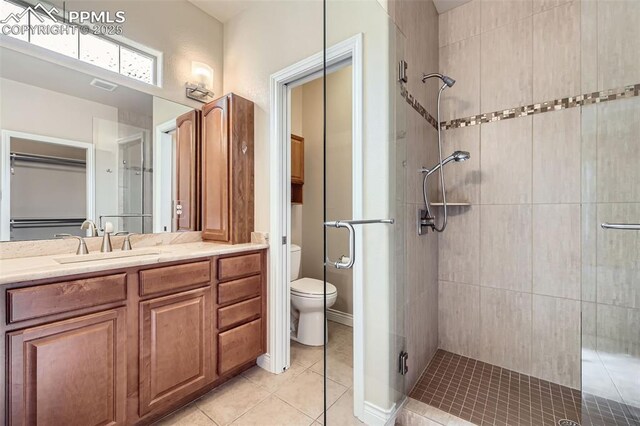 2252 Conservatory Pt, Colorado Springs, CO 80918 - bathroom featuring a stall shower, toilet, vanity, and tile patterned flooring