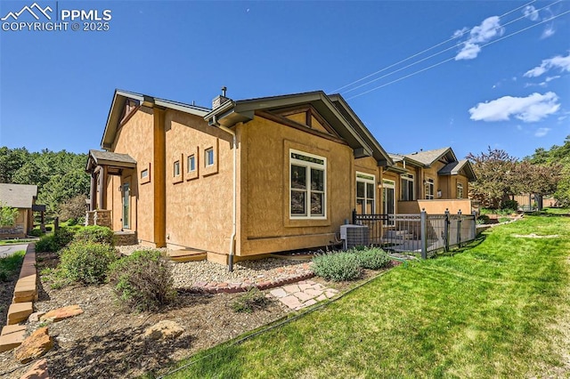 2252 Conservatory Pt, Colorado Springs, CO 80918 - rear view of house featuring cooling unit and stucco siding
