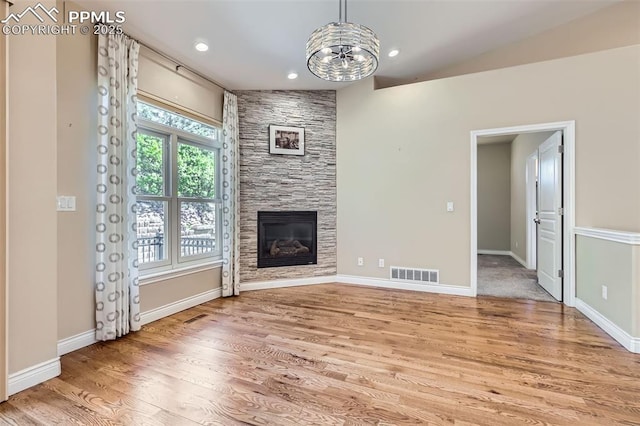 2252 Conservatory Pt, Colorado Springs, CO 80918 - unfurnished living room featuring a chandelier, light wood-style floors, a fireplace, baseboards, and recessed lighting