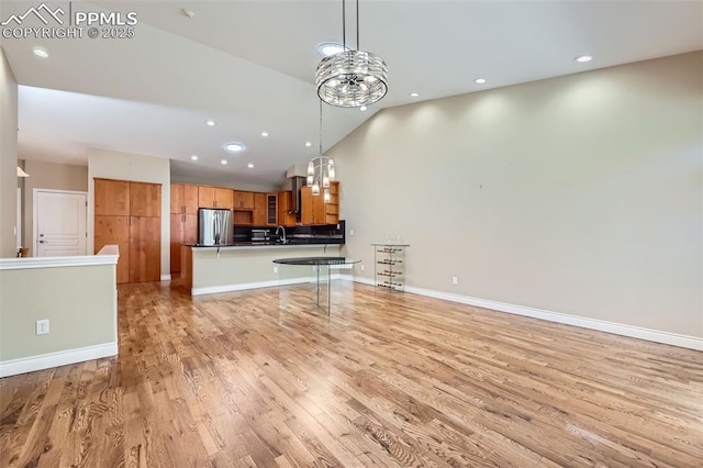 2252 Conservatory Pt, Colorado Springs, CO 80918 - unfurnished living room featuring light wood-style flooring, recessed lighting, high vaulted ceiling, and baseboards