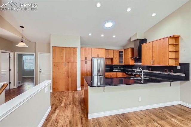 2252 Conservatory Pt, Colorado Springs, CO 80918 - kitchen featuring open shelves, freestanding refrigerator, wall chimney range hood, a peninsula, and light wood-type flooring