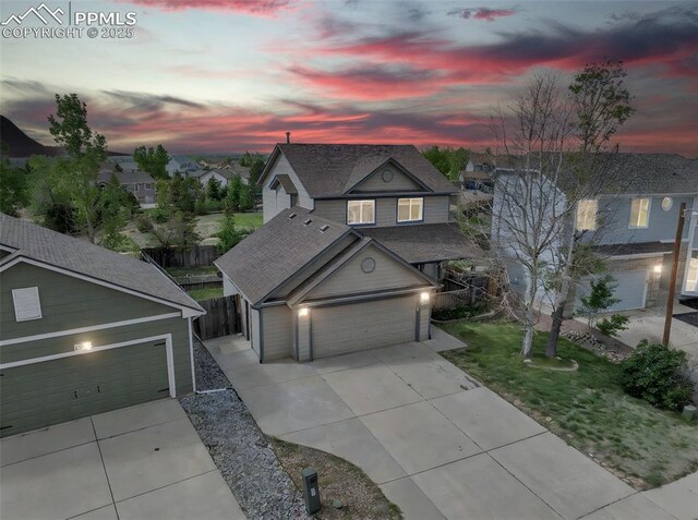 12572 Catch Pen Rd, Peyton, CO 80831 - traditional-style house featuring concrete driveway, a shingled roof, a garage, and a residential view