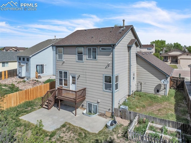 12572 Catch Pen Rd, Peyton, CO 80831 - rear view of property with a patio, a fenced backyard, a wooden deck, and roof with shingles