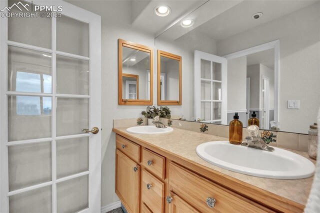 12572 Catch Pen Rd, Peyton, CO 80831 - bathroom featuring double vanity and recessed lighting