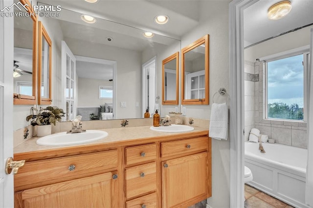 12572 Catch Pen Rd, Peyton, CO 80831 - ensuite bathroom with double vanity, toilet, recessed lighting, and ceiling fan