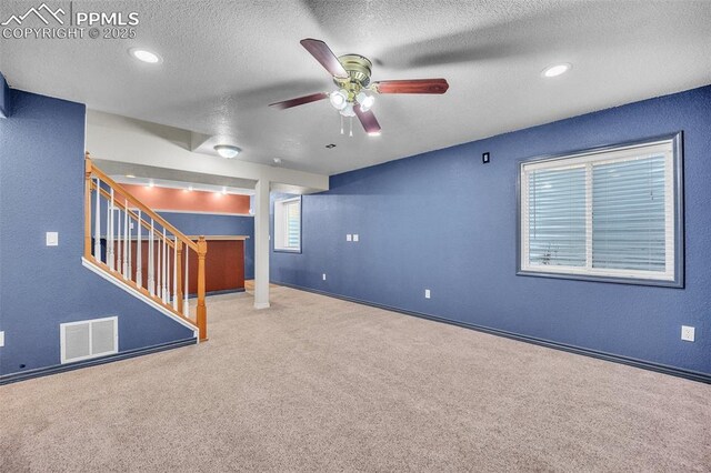 12572 Catch Pen Rd, Peyton, CO 80831 - basement with a ceiling fan, a textured ceiling, carpet, stairs, and baseboards