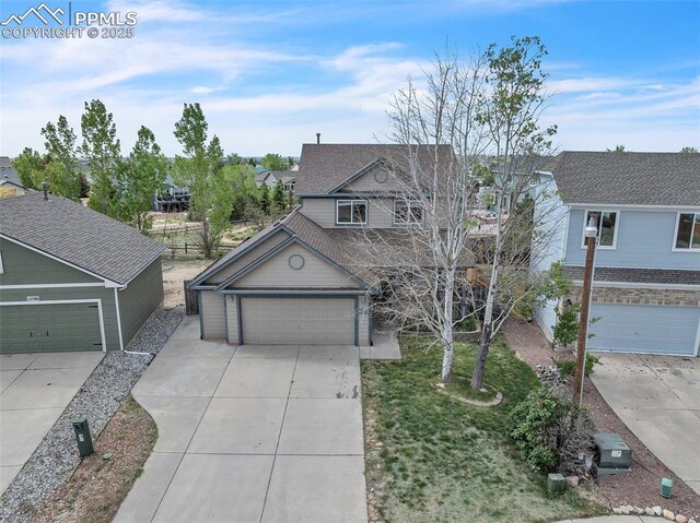 12572 Catch Pen Rd, Peyton, CO 80831 - view of front of property featuring a garage, concrete driveway, and a residential view