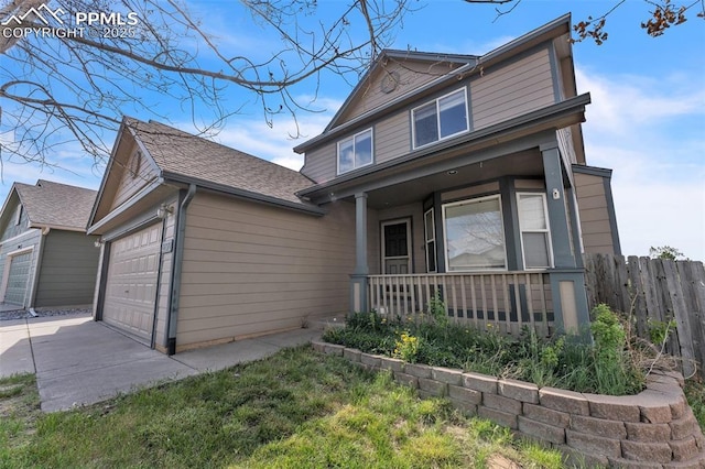 12572 Catch Pen Rd, Peyton, CO 80831 - view of front of house featuring a porch, concrete driveway, an attached garage, and roof with shingles