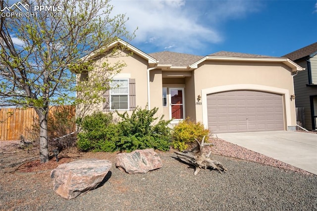 1985 Reed Grass Way, Colorado Springs, CO 80915 - single story home with stucco siding, concrete driveway, and an attached garage