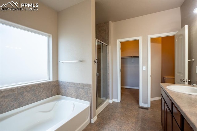 1985 Reed Grass Way, Colorado Springs, CO 80915 - full bath with a shower stall, a garden tub, vanity, tile patterned flooring, and a walk in closet