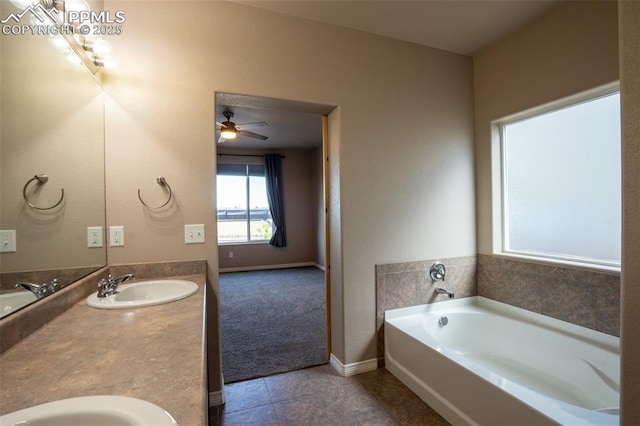 1985 Reed Grass Way, Colorado Springs, CO 80915 - full bath featuring double vanity, a bath, tile patterned flooring, baseboards, and a ceiling fan