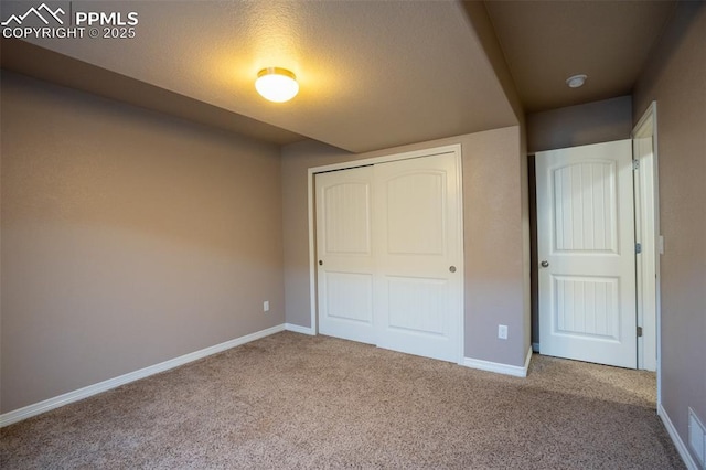 1985 Reed Grass Way, Colorado Springs, CO 80915 - unfurnished bedroom featuring a closet, carpet floors, and baseboards