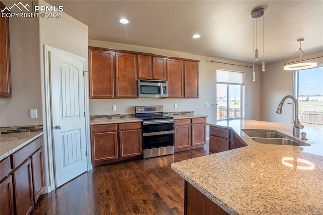 1985 Reed Grass Way, Colorado Springs, CO 80915 - kitchen with appliances with stainless steel finishes, a sink, plenty of natural light, dark wood-style floors, and recessed lighting